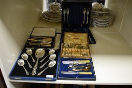 A cased silver plated dessert spoon set of Art Deco design and comprising nine spoons of different