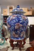 A 19th/20th Century Chinese vase and cover on stand, of bulbous form and decorated with a foliate