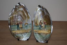 A pair of 19th Century French painted mussel shells, depicting coastal scenes with figures and