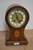 An Edwardian balloon shaped mantel clock, the oak and satinwood inlaid case enclosing an enamelled