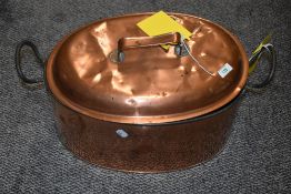 A 19th Century lidded copper fish kettle with cast iron carrying handles, measuring 55cm long