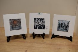 Janine Partington (Contemporary, British), three enamelled tile designs in painted white wooden