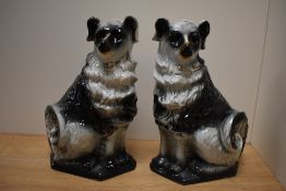 A pair of 19th/20th Century Scottish Bo'ness pottery black and white dogs, with gilt accents and