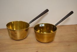 Two 19th Century brass sauce pans with cast iron handles, each measuring 30cm long