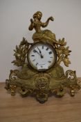 A late 19th Century French gilt metal mantel clock with key, having a figural surmount above an