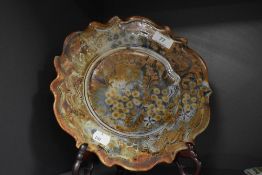 A mid-20th Century studio pottery plate, having a shaped outline and decorated in an Italian style