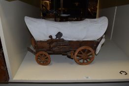 A 20th Century model of a covered wagon, measuring 45cm long