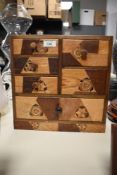 An early 20th Century Japanese marquetry table chest, having an arrangement of seven fitted
