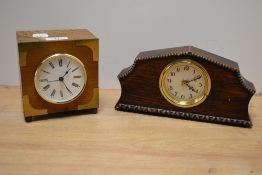 A 20th Century oak and brass bound mantel clock, the case enclosing an enamelled Roman dial,