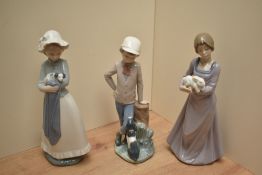A group of three Nao by Llardo figurines comprising 'Affectionate Pup' number 380, 'Precious Bundle'