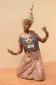 A large and attractive Lladro porcelain female Thai/Siamese dancer figurine, modelled kneeling and