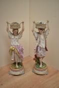 A pair of 19th century French Gille Jeune (Paris) bisque porcelain basket carrier figures,