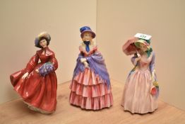A group of three Royal Dulton bone china figurines, comprising Victorian Lady HN728, Lilac Time