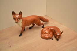 Two Beswick Pottery fox studies, Fox-Standing 1016a designed by Arthur Gredington, in red, brown and