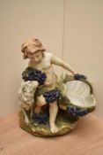 A Capodimonte style figure depicting a young boy with basket having blue berry decoration,