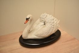 A Ronald Van Ruyckevelt for The Franklin Mint 'The Royal Swan' bisque porcelain bird study raised on