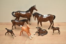 A group of seven Beswick pottery horses and foals, to include a Palomino foal, mare facing left,