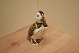 A Royal Crown Derby bone china Puffin paperweight having markings and coloured silver stopper to