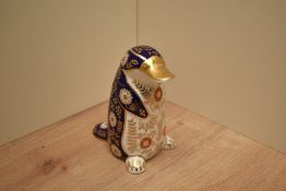 A Royal Crown Derby bone china Platapus paperweight having markings and gold coloured stopper to