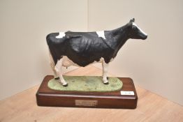 A John Harper Shebeg Pottery (Isle of Man) study of a Friesian cow, modelled standing, marked Harper