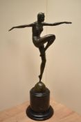 An Art Deco design patinated metal figure of a female dancer on a turned marble base, signed J.