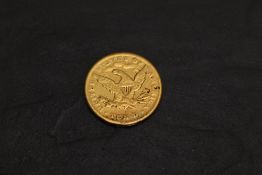 A USA 1879 Ten Dollar Gold Coin, Liberty (coronet head) facing left, surrounded by 13 stars, with