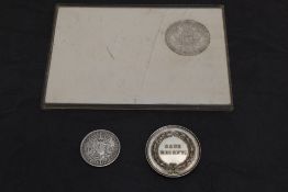 A Maria Theresa Silver Thaler in plastic case along with a 1937 South Africa Silver 2 1/2 Shilling