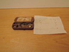 A Guinea Coin Scale and Weights in wooden box with label to inside of lid
