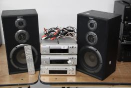 A Denon midi system with speakers and remote