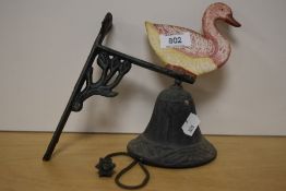 A wall mounted cast iron doorbell having duck design.