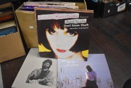 A nice selection of LP records including a four compact disc collection from Eric Clapton-