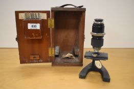 A vintage Britex Minor 2037 students microscope, cased with seven sample slides, used with scratches