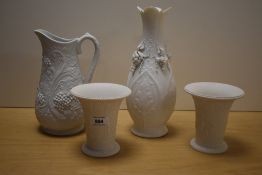 A pair of Continental bisque porcelain vases, of flared cylindrical form, decorated with repeating