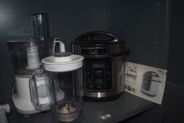 A Pressure King Pro 8 in 1 digital pressure cooker with instructions and a Kenwood food processor a