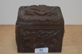 A Chinese hardwood humidor, carved in relief with dragons and birds, measuring 11cm x 12cm x 8cm