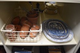 A selection of terracotta planters in varied sizes sold alongside four blue and white ashettes.