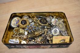 A collection of costume brooches, including paste set examples, miniature embroidery, statement