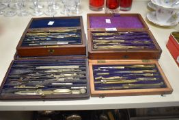 Four cased draughtsman's sets with cloth lined interiors