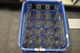 A milk bottle crate containing twenty glass milk bottles titled ' Bradleyfield Dairy Kendal'.