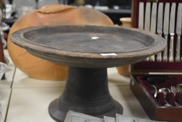 A vintage turned wood round pedestal tray, standing at 25cm tall with signing to the base.
