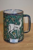 A 20th Century Jerusalem pottery tankard of Faience style, decorated in polychrome with a gazelle