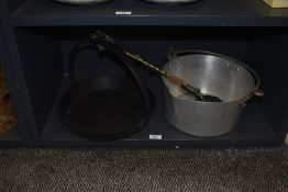 A 19th Century cast iron skillet pan, the base unmarked with a diameter of 32cm, a stainless steel