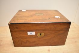 A 19th Century walnut writing slope, the ebony strung case opening out to a tooled leather and