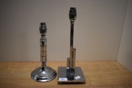 A chromed metal table lamp base of geometric form and raised on a four footed base, measuring 32cm