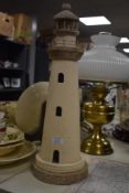 An attractive hand crafted lighthouse sculpture, finished in cream and measuring 54cm high