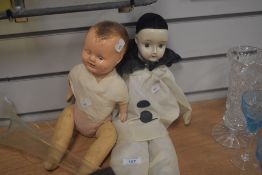 An early 20th Century composition headed doll, with painted facial features, soft, jointed body with