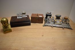 An early 20th Century oak desk stand with inkwells, measuring 18cm long, a white metal engraved desk