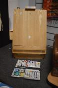 A modern pine artist's easel and storage box, measuring an elevated height of 50cm, together with