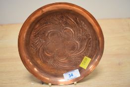 A Keswick School of Industrial Arts circular copper dish with repousse decoration of scrolling