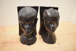A pair of African carved hardwood figural bookends, each measuring 21cm high